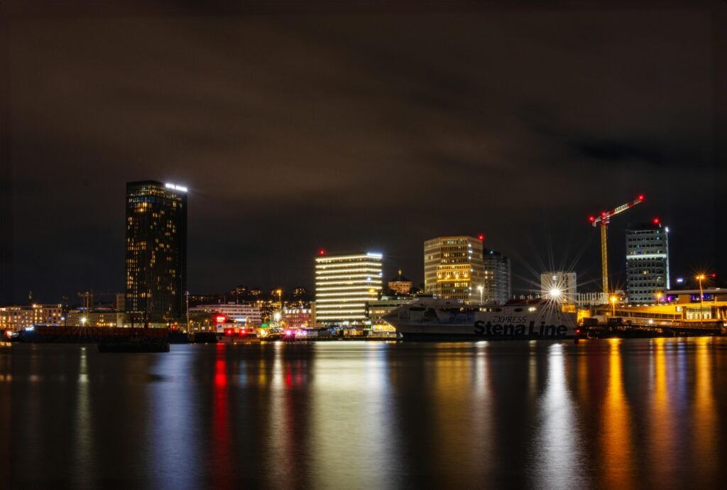 Illuminated cityscape of Göteborg with Stena Line ferry at night.